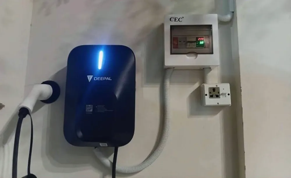 Deepal 7 kW EV wall charger installed beside a CEC distribution box with a voltage and current meter