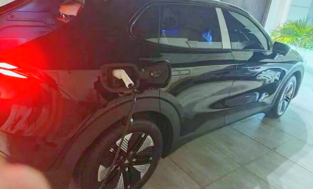 Electric SUV plugged in and charging from the newly installed wall charger