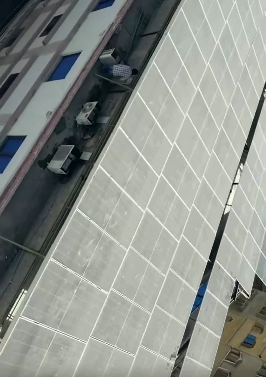 Aerial view of a 2 × 50 kW solar array on an elevated structure at a Karachi nursing school
